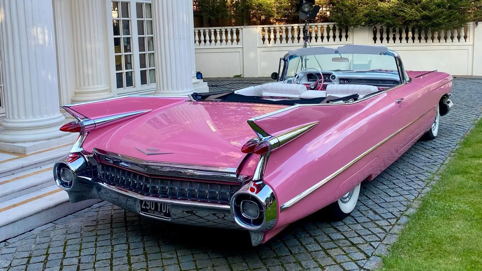 Rear View Pink cadillac showing High Fin Tails and Chrome Bumper