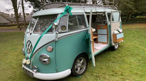 Classic Volkswagen Campervan in Light Green and White Roof with wedding ribbon deocration and flowers