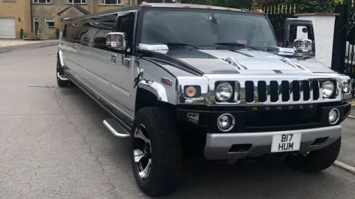 Silver 16-seater Stretched Hummer with white ribbons waiting for Groosmen in York