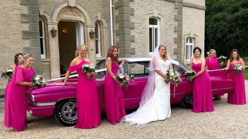 Pink American Cadillac with Bride in White Dress and her Bridesmaids wearing Pink dresses in front of Wedding Ceremony in Bath