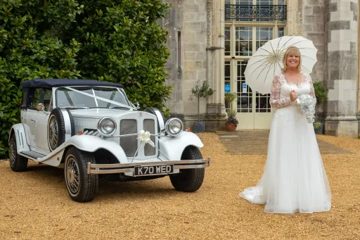 Vintage Beauford with Bride in White Dress holding White umbrella