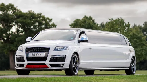 8-seater Stretched Audi Q7 Limousine in White entering wedding venue in Lincoln