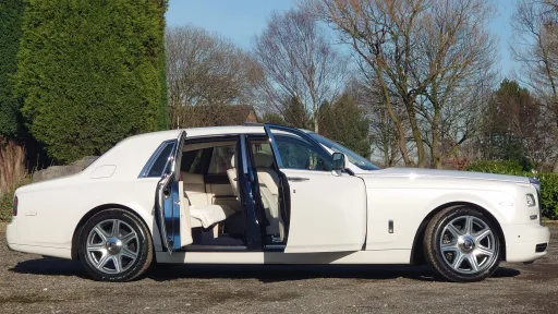 Side View of White Rolls-Royce Phantom Series 2 with door open showing cream leather interior