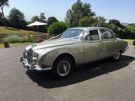 Classic Daimler Saloon Car on wedding duty with white ribbons in Devon