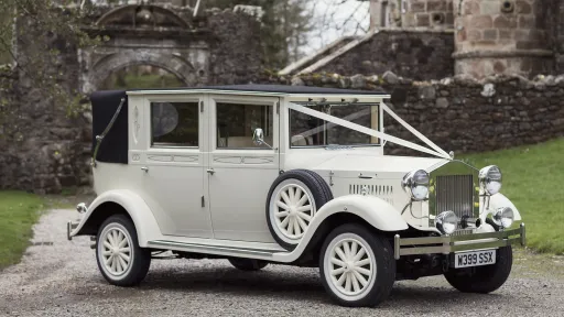 Vintage Imperial Convertible in Cream with Traditional V-Shape White Ribbons in Scottish Highlands.