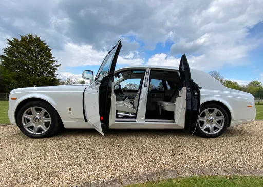 Side View of White Rolls-Royce Phantom with door open showing cream leather interior