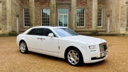 Side modern Rolls-Royce Ghost showing the alloy wheels and dark tinted windows