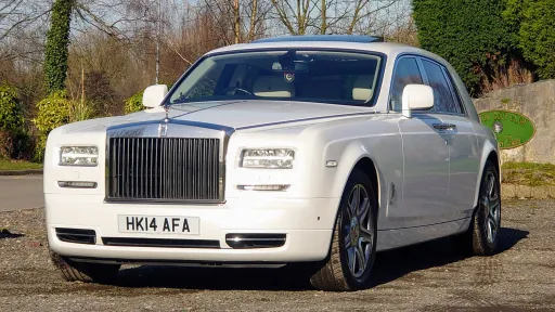 White Rolls-Royce phantom Series 2 in Denbighshire on wedding duties waiting outsid the wedding Reception