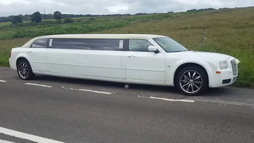 Side View of White Stretched Wedding Limousine with Ribbons
