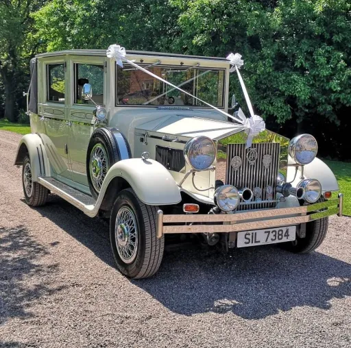Silver vintage regent car entering wedding venue in West Yorkshire with White Ribbons