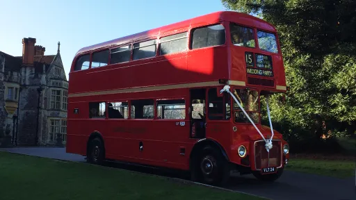 Double Decker Red Routemaster bus with White Ribbons at front
