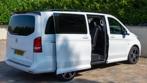 Side view of White 8-seater mercedes mini bus