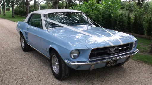 Baby Blue with white roof Classic Mustang hire in Hertfordshire. Car is dressed with white ribbons