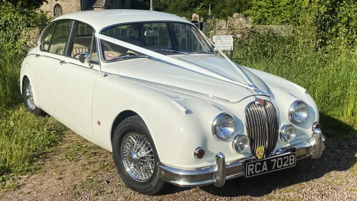 Classic Jaguar with White ribbon in Gloucestershire country side
