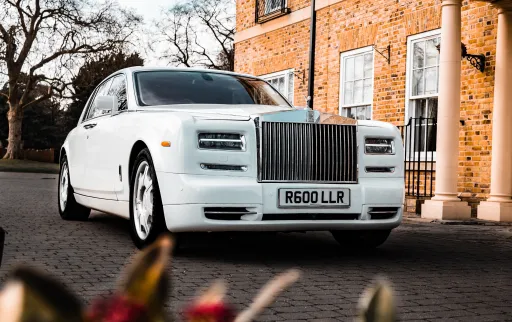 White Modern Rolls-Royce at a wedding venue in Kent