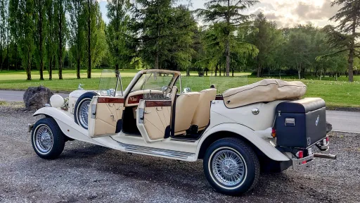 1930's Vintage Style 4-door Beauford Wedding Car with open roof and opended doors showing the cream leather interior