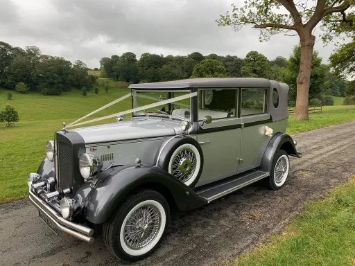 Vintage style Silver 6-seater Regent Convertible decorated with white ribbons in the Staffordshire Country side