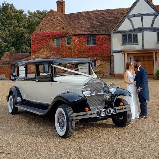 Bride and Groom next to their wedding car hired for their wedding at Lillibrooke manor in Berkshire.