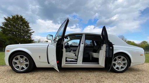 Side View of White Rolls-Royce Phantom with door open showing cream leather interior