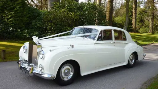 Ivory Classic Rolls-Royce for hire on isle of wight. Decorated with wedding ribbons