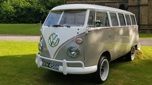 Front side view of campervan in two tone White and Bronze waiting for wedding couple to come out of their venue in Nottinghamshire