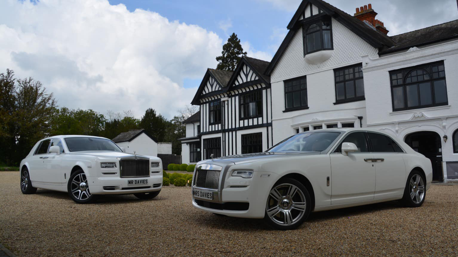 Two Modern Rolls-Royce Phantom and Ghost in White in front of a wedding venue in Canterbury