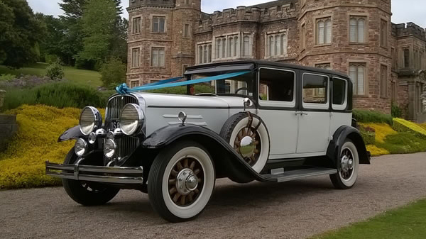 White vintage american Franklin car at a local wedding venue in Bude.