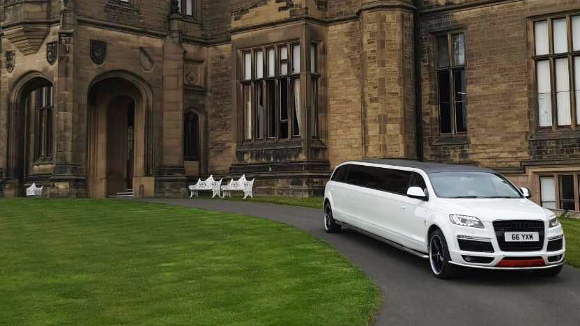 White Audi Q7 stretched limousine in front of a wedding venue in Lancashire