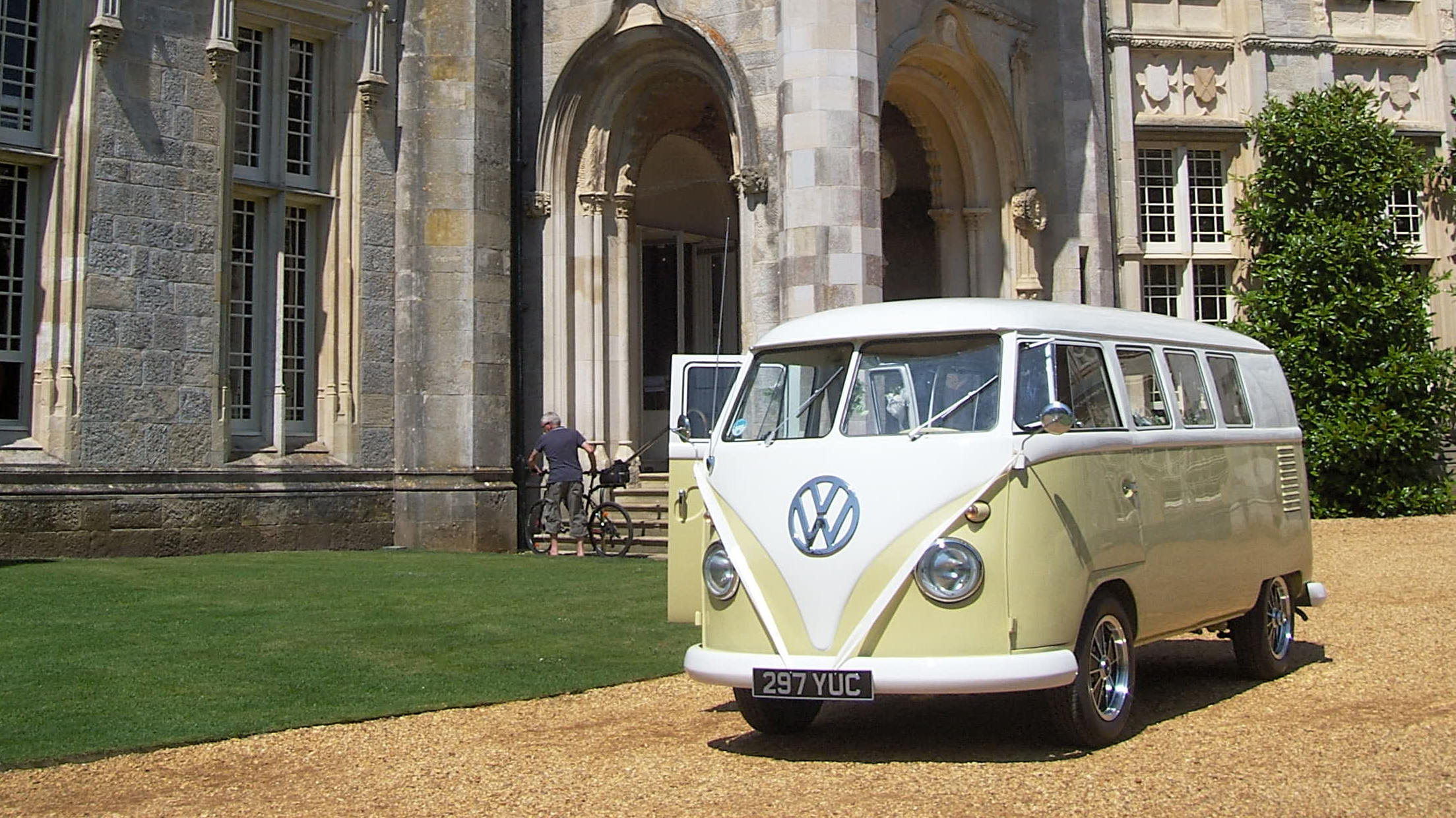 Retro Classic Volkswagen Campervan decorated with white ribbons at a local Okeford Fitzpaine wedding venue.