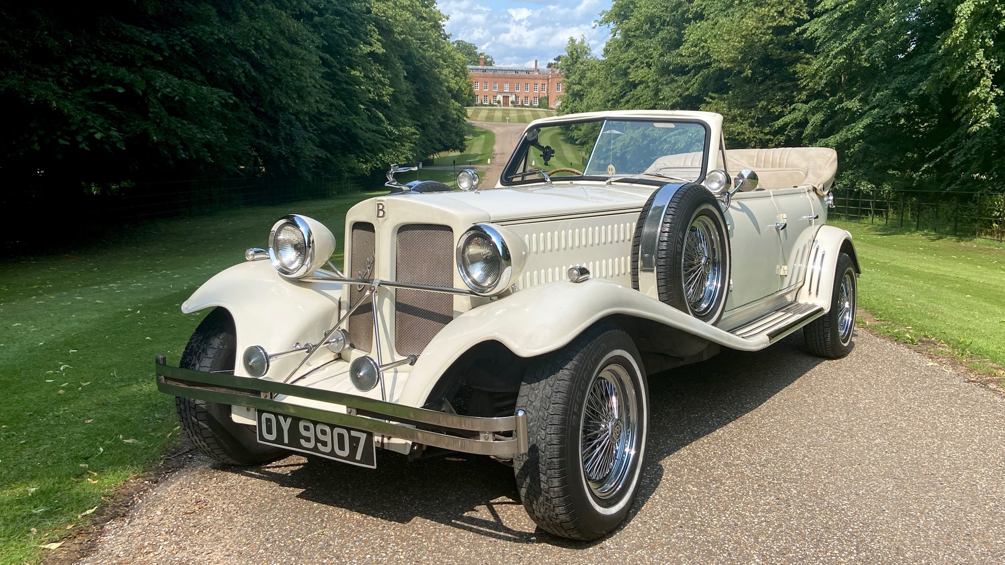 Vintage Beauford Convertible with roof down and spare mounted wheel on the left side