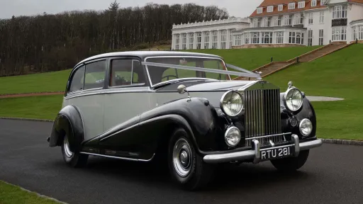 Side View of Classic Rolls-Royce with White Wedding Ribbons driving in street Dumfries and Galloway.