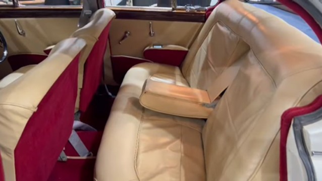 Rear inside seating with cream interior, deep red carpets/
