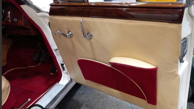 Interior front view of cream door panel from chauffeur's side