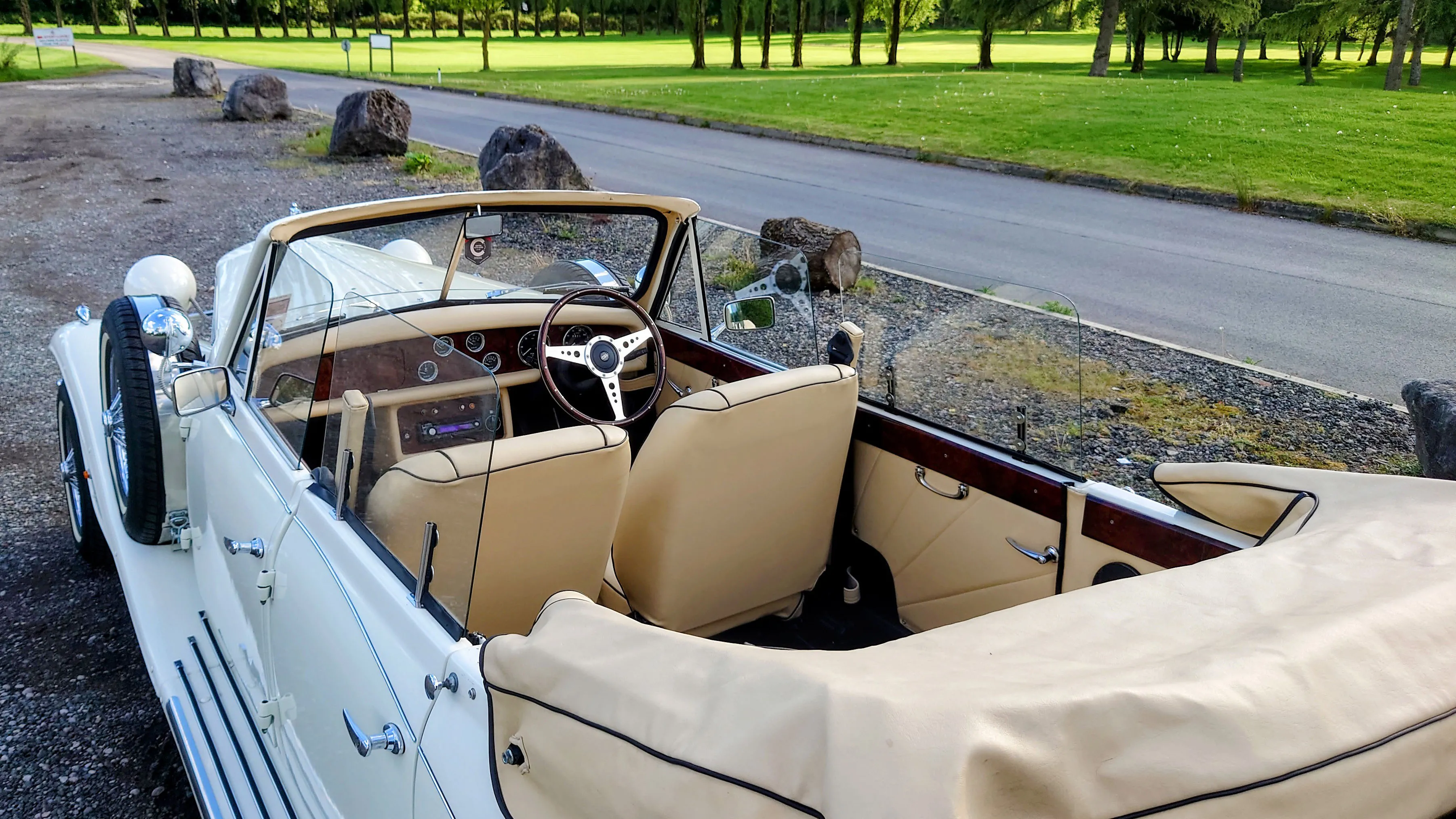 Vintage Beauford with fully opened roof showing the cream leather inerior seating