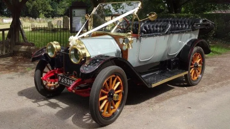 Side view of a Vintage Convertible Wedding car waiting for Bride and Groom in front of Church in Bedfield