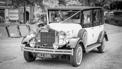 Black & White Imperial Convertible in street of Lincoln decorated with White Ribbon