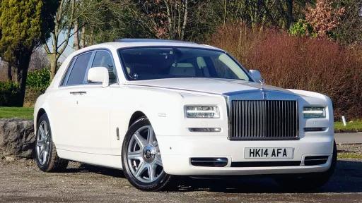 White Phantom Series 2 showing front chrome grill, very shiny alloy wheel and forest background