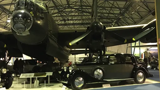 Vintage Rolls-Royce in Grey and Black under a vintage Plane in a museum in Norfolk