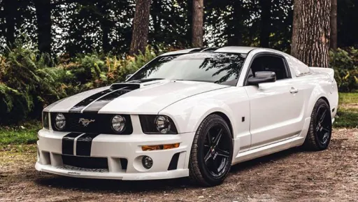 Ford Mustang wedding Car in White with two black strip accross the length of the car. Photo was taken in Exmoor national park in Devon