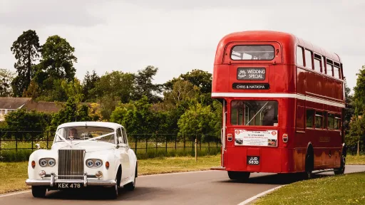 Classic Rolls-Royce and a Vintage Routemaster Bus decorated with White Ribbons at a Wedding in North Wales.