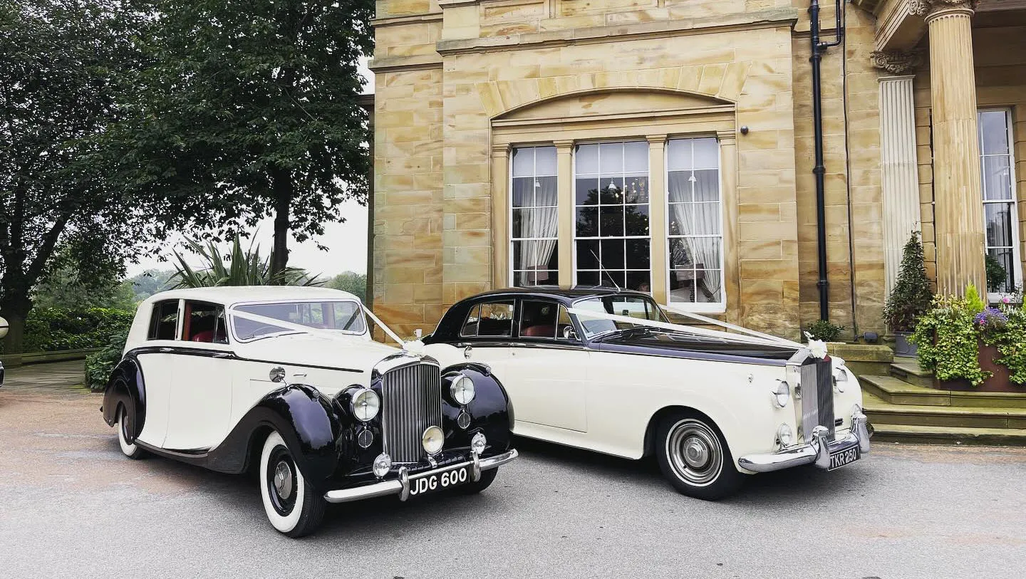 Black & White Classic Rolls-Royce on wedding duties both have V-Shape White Ribbons on their bonnet