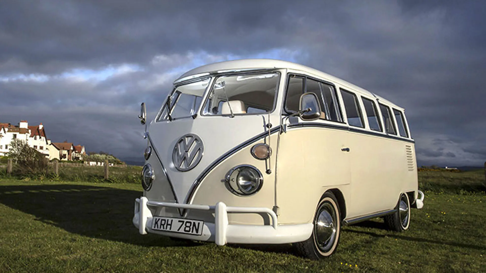 Classic VW splitscreen Camper in white over cream in a green field