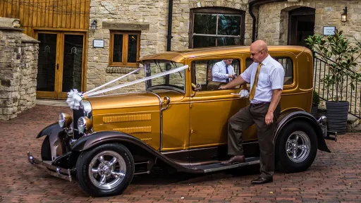 Ameriocan Ford Model A Hot Rod in Burnt Orange decorated with White Ribbons and bow on front grill