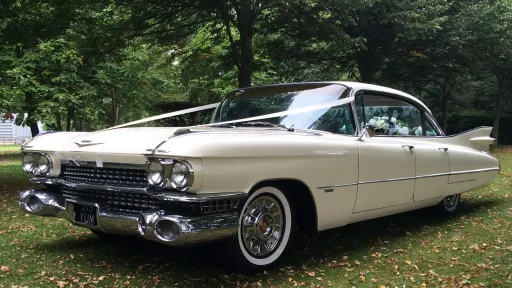 American Cadillac decorated with traditional wedding ribbons accross his bonnet