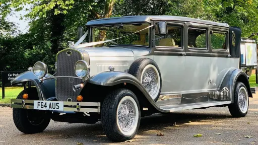 Side view of 7-seater Bramwith in Bronze & White decorated with white wedding ribbons on its bonnet. Spare wheel is mounted on wheel arches