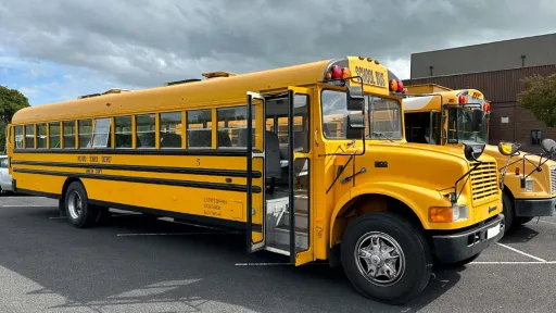 American Yellow School Bus for hire in Staffordshire. Side view showing the double door opening