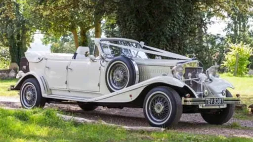 Vintage Beauford hire in London and decorated with white ribbons in Richmond Park