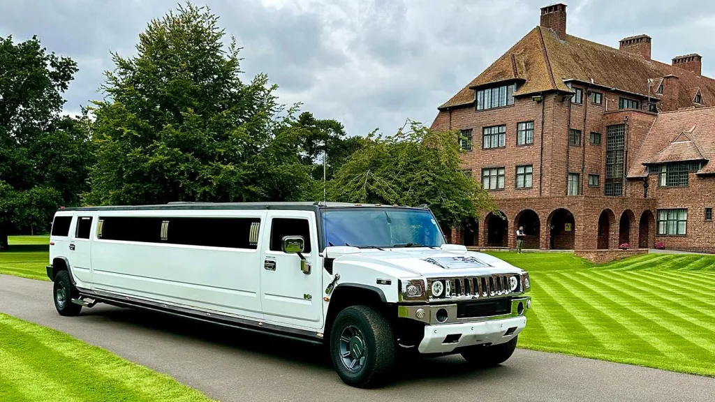 White Stretched Hummer Limousine in front of wedding venue