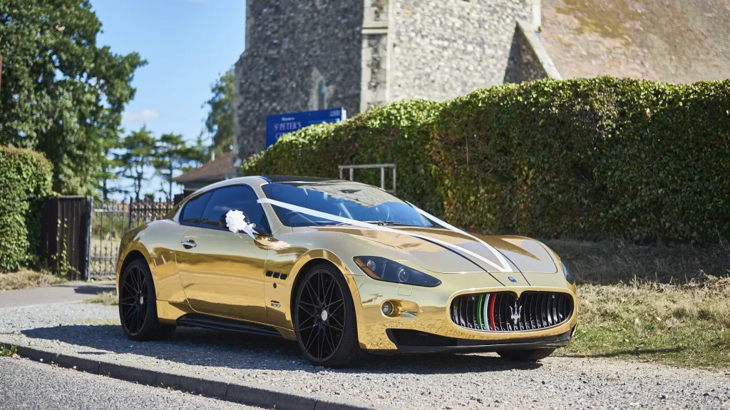 Modern Maserati in Gold in front of Church