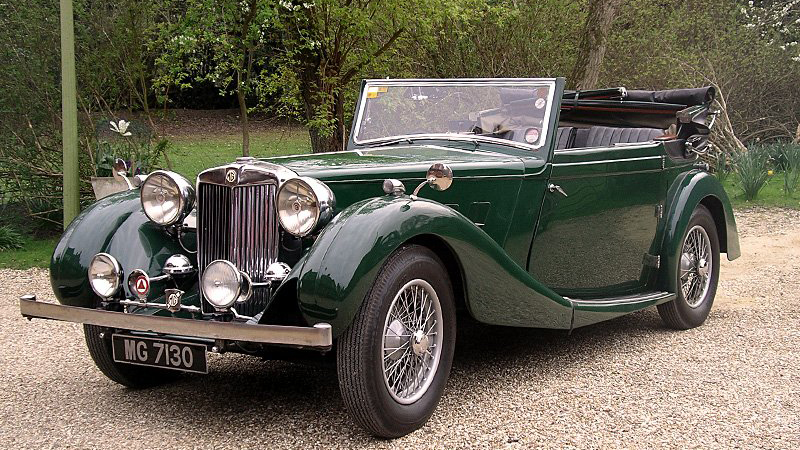 Green Vintage MG Convertible with roof open showing black leather interior